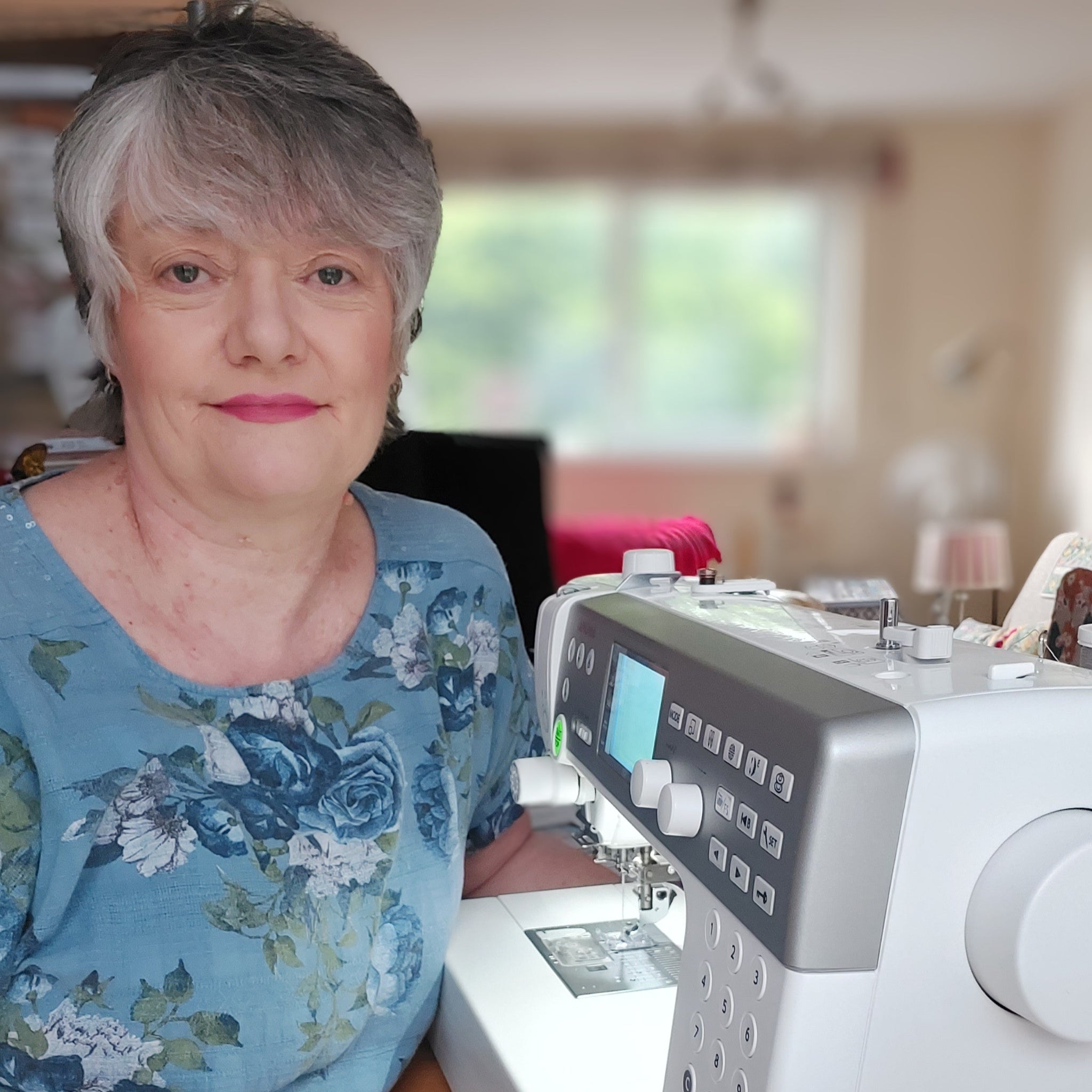 Woman sitting at a sewing machine in a home setting