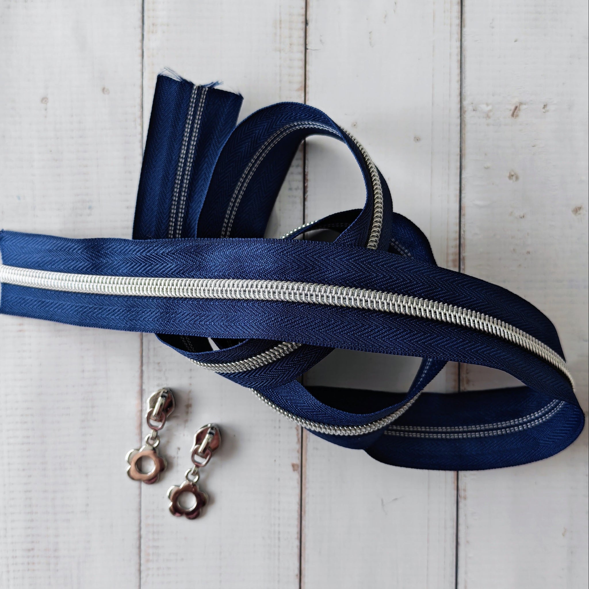 Navy zipper with two flower shaped zip pulls
