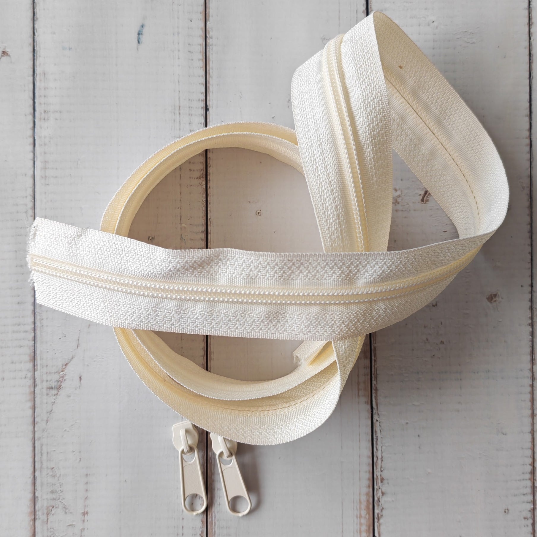 Cream zipper with two cream zipper pulls