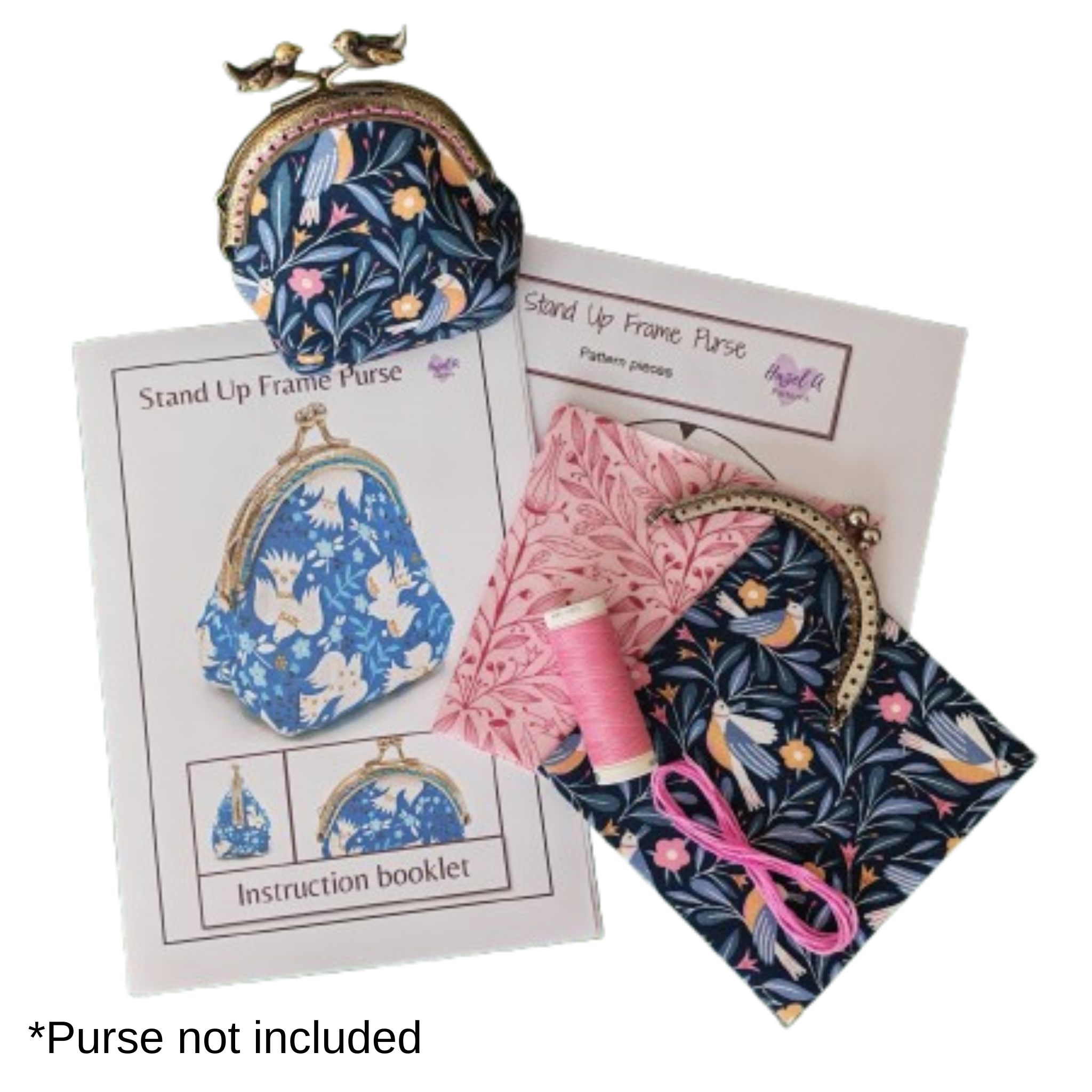 Pink and navy patterned fabrics, a printed pattern for a stand up frame purse, sewing thread and purse frame.