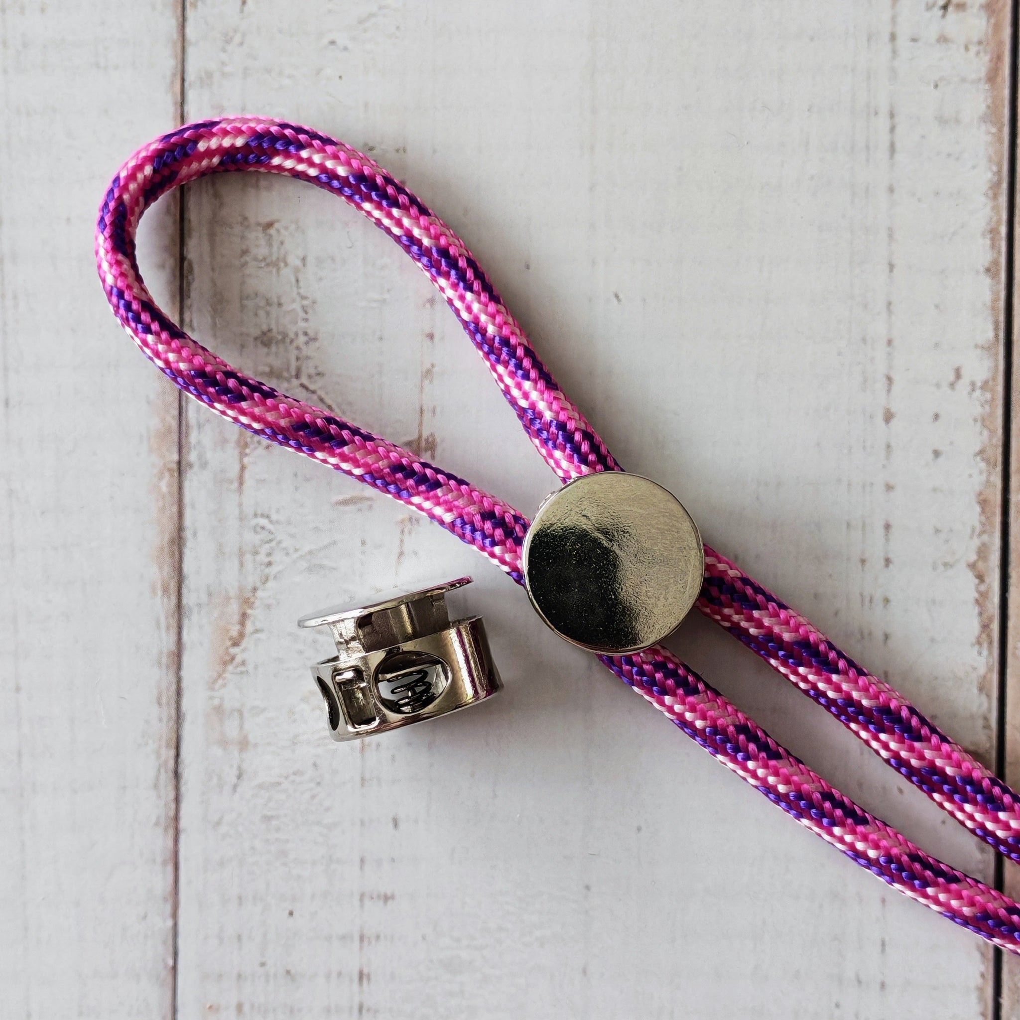 Pink and purple braided lanyard with metal cord locks.