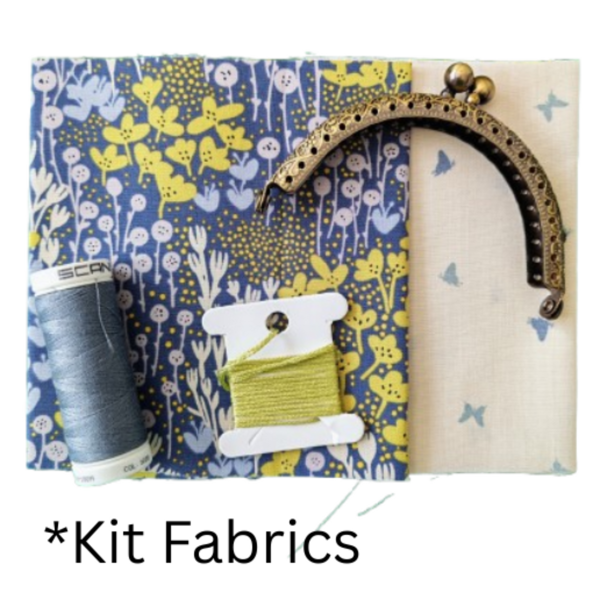 Blue fabric with yellow and white floral print, a cream fabric with small blue butterflies, a spool of grey thread and embroidery thread.