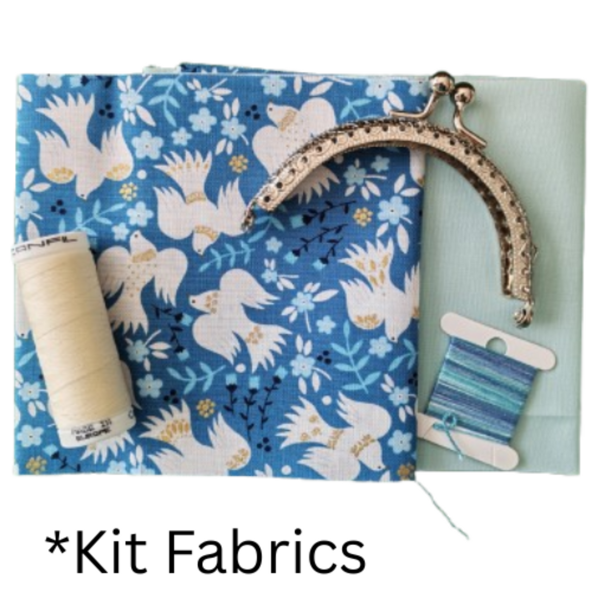 A fabric kit featuring blue fabric with cream Doves, a spool of cream thread, embroidery thread, and an ornate silver-tone metal kiss-lock purse frame.