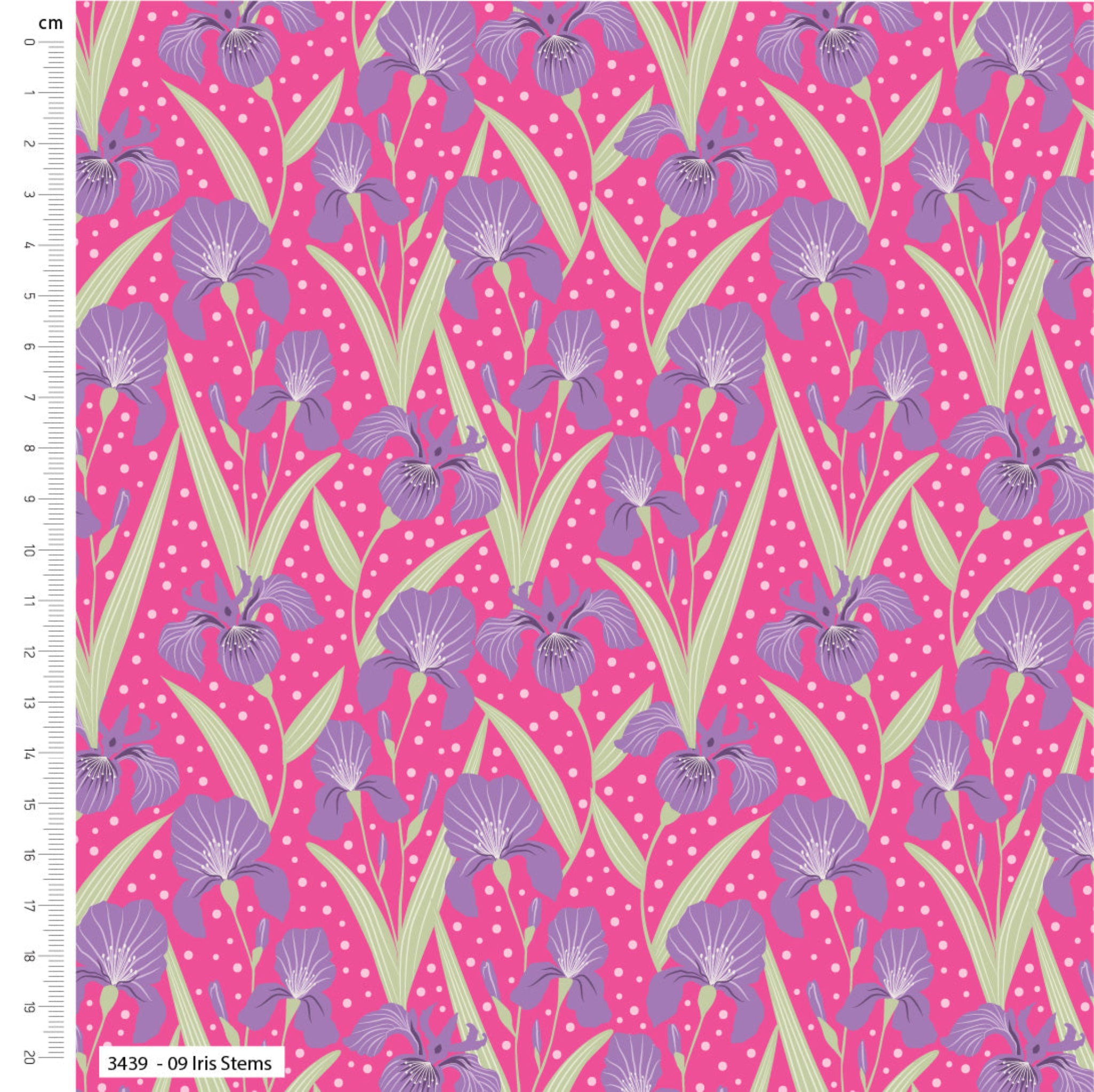 Fabric with purple iris pattern on a pink background, measured against a ruler. 100% cotton fabric.