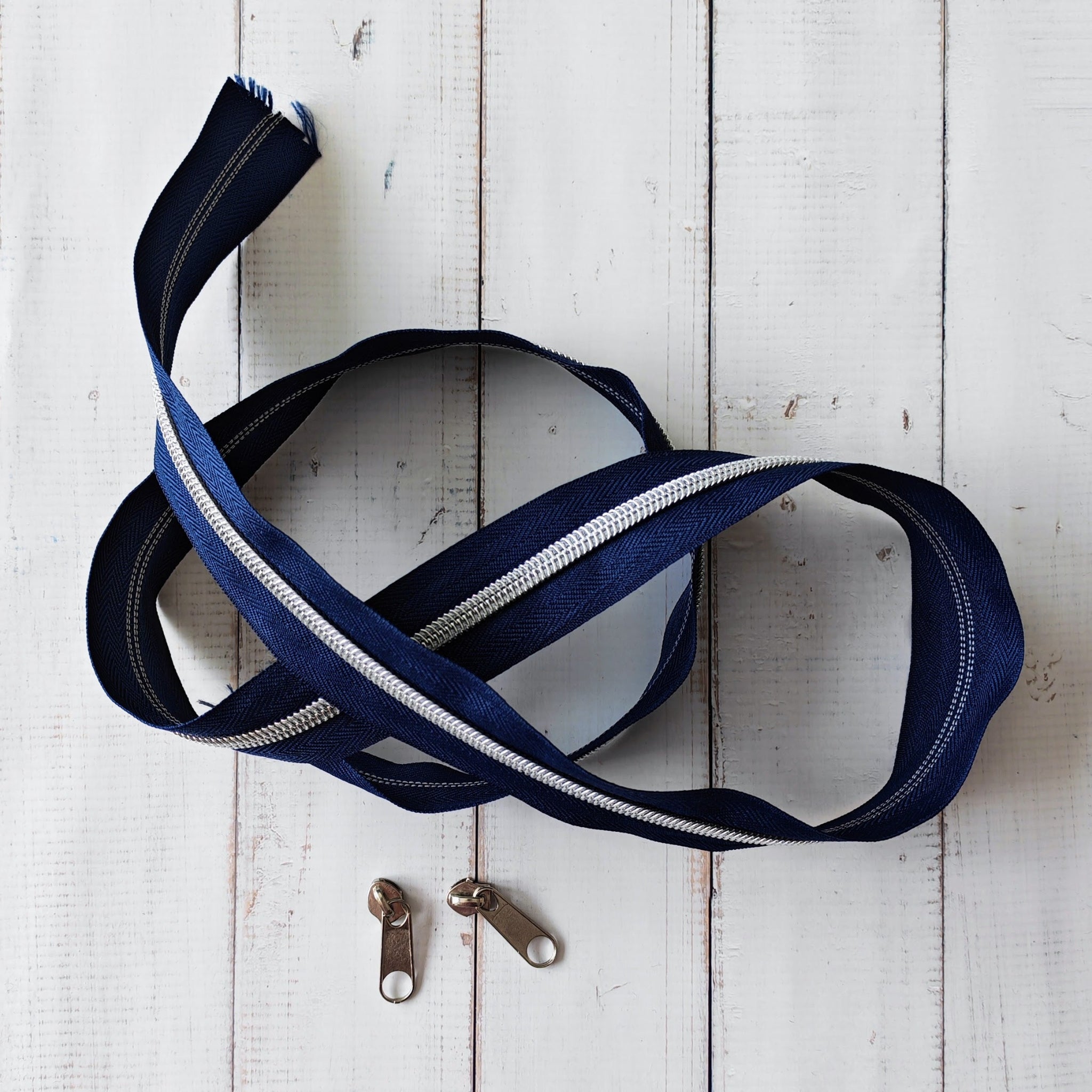 #5 Navy blue zip with silver teeth and two silver zipper pulls
