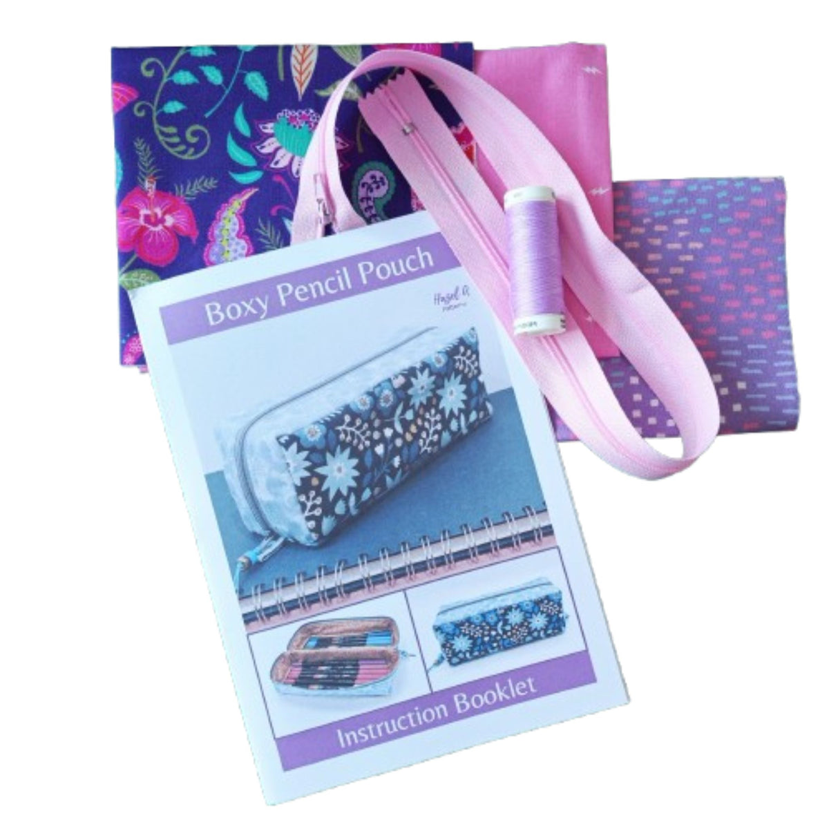Boxy Pencil Pouch sewing pattern kit, a pink zipper, a spool of lavender thread, and an instruction booklet.