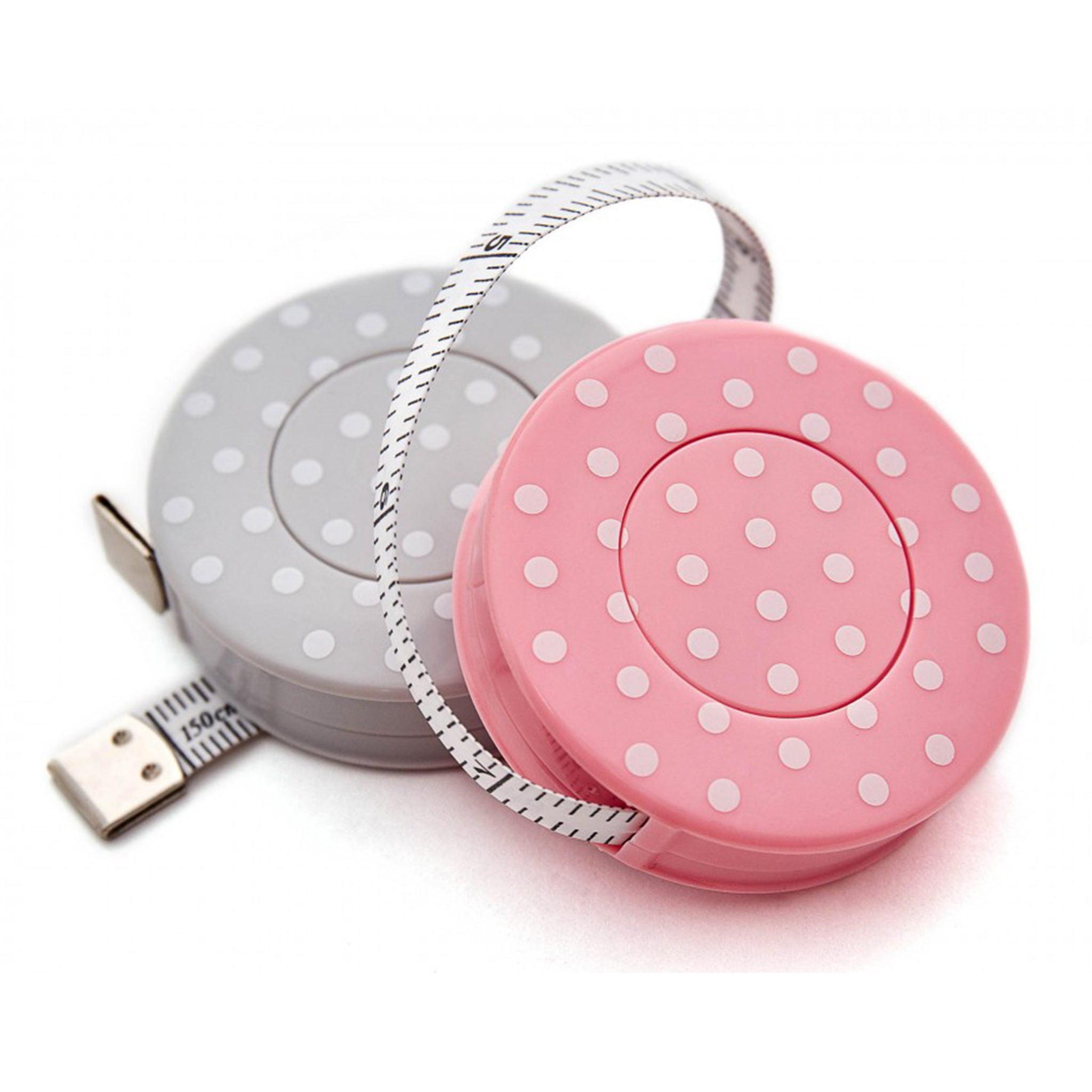 Two compact retractable tape measures with round plastic housings, one pink and one gray, both decorated with white polka dots, shown on a white background.