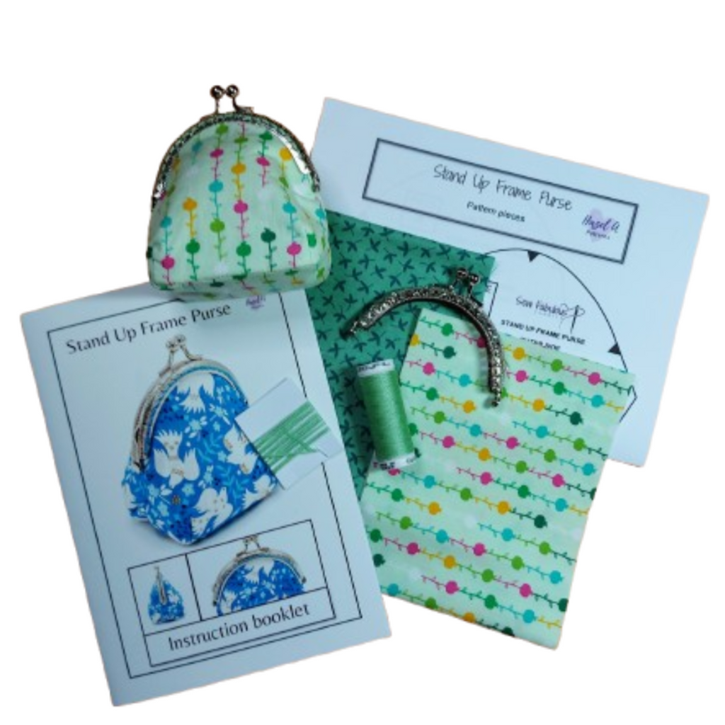 Stand-up frame purse kit with patterned purse, frame, thread, and instruction booklet 