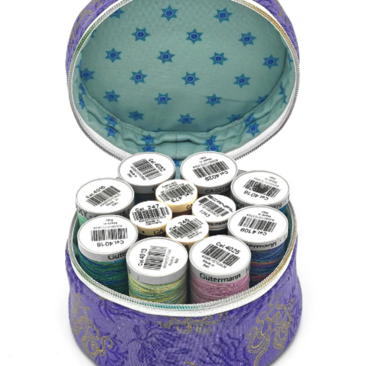 An open purple zippered fabric case filled with multiple spools of thread. The case has a purple patterned exterior, and a light aqua patterned lining.