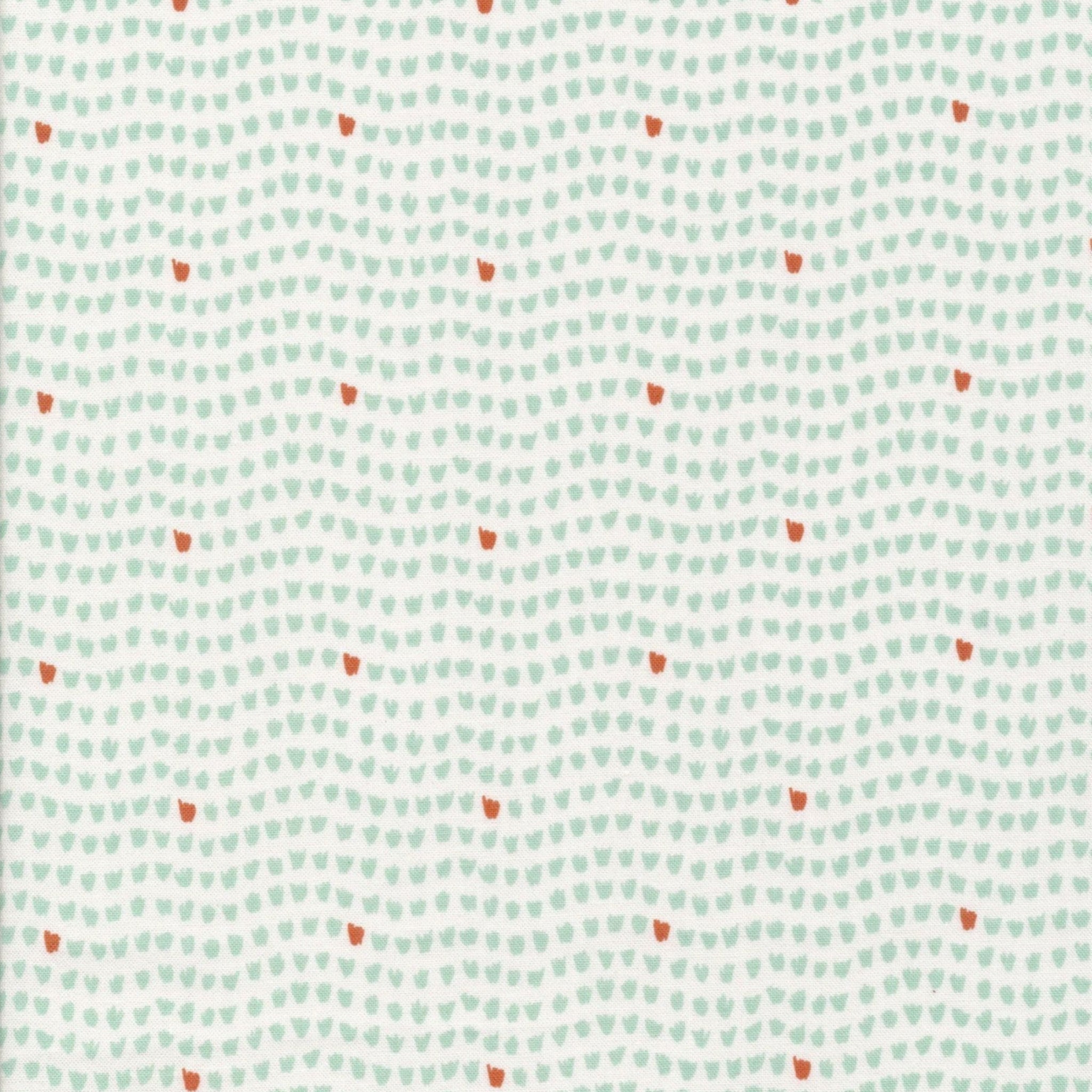Patterned fabric with small red and green shapes on a light blue background. 100% cotton fabric.
